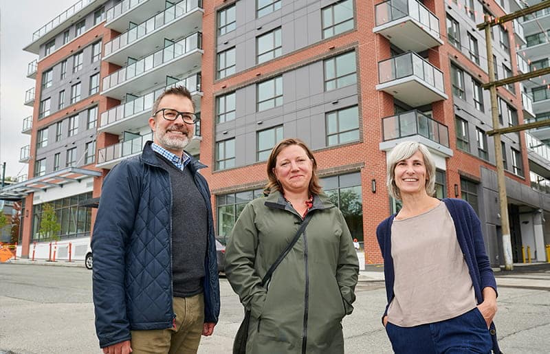 3 people standing in front of the Aspen development on Main Street